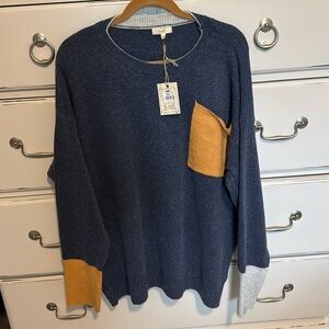 Very soft sweater with pocket and contrasting cuffs.